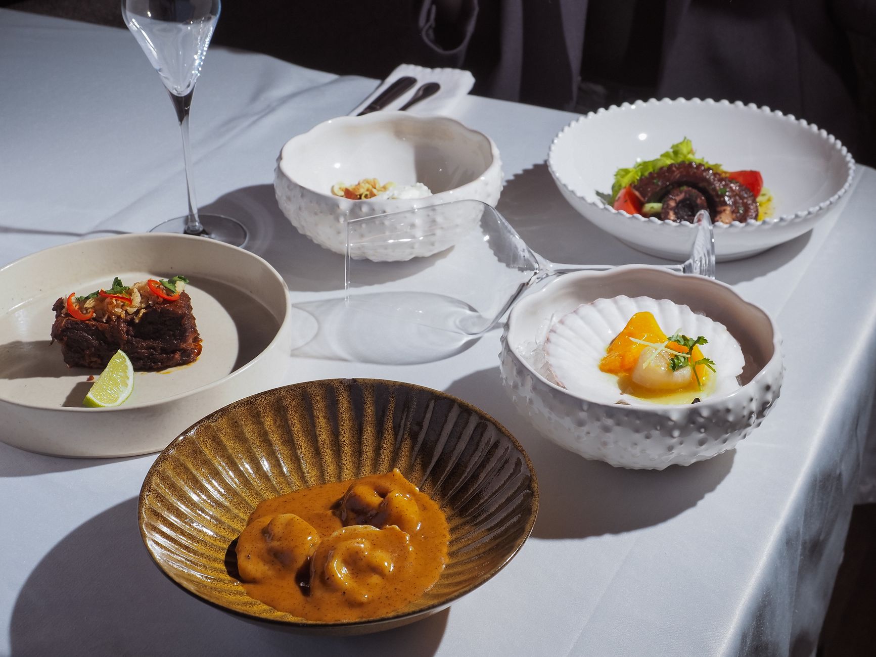 A table arranged with colorful restaurant dishes